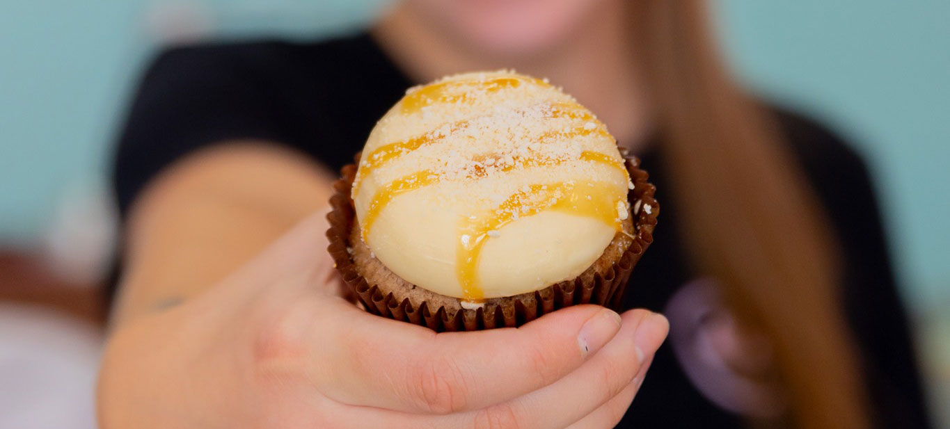 Female holding a cupcake in front